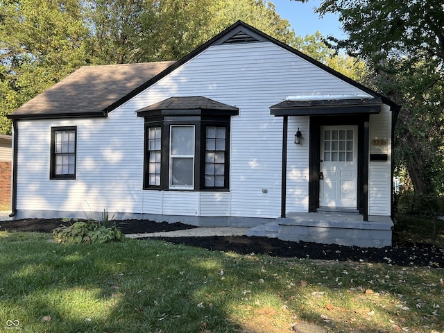 937 N Routiers Ave, Indianapolis, IN 46219 - view of front of home with a front lawn and a shingled roof