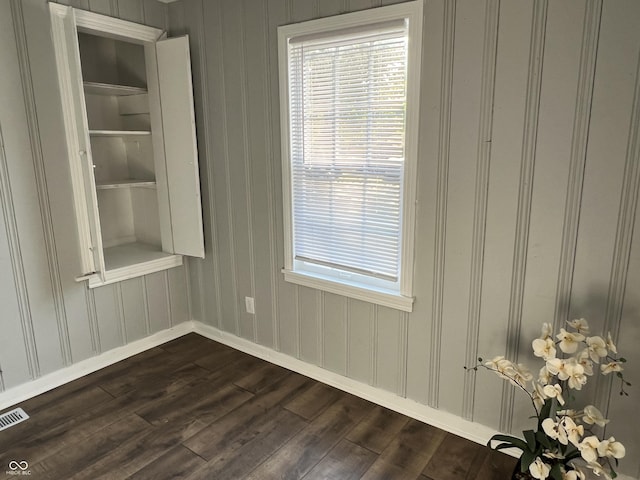 937 N Routiers Ave, Indianapolis, IN 46219 - unfurnished dining area with dark wood-style floors and baseboards