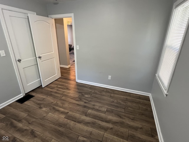 937 N Routiers Ave, Indianapolis, IN 46219 - unfurnished bedroom with dark wood finished floors and baseboards