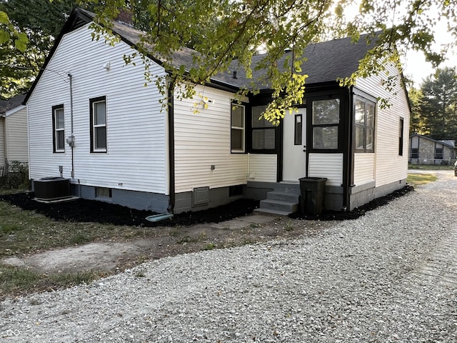 937 N Routiers Ave, Indianapolis, IN 46219 - rear view of property with roof with shingles and a chimney