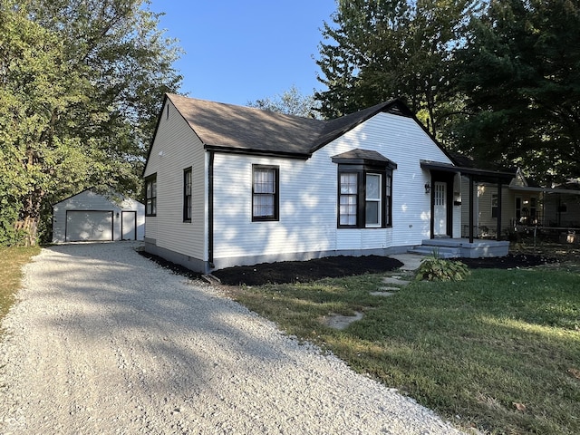 937 N Routiers Ave, Indianapolis, IN 46219 - view of front of home with a garage, an outbuilding, roof with shingles, a front yard, and driveway