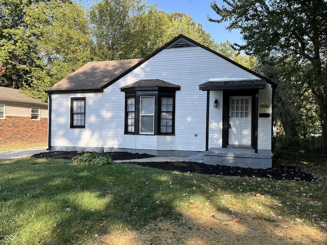 937 N Routiers Ave, Indianapolis, IN 46219 - view of front facade with a front lawn and a shingled roof