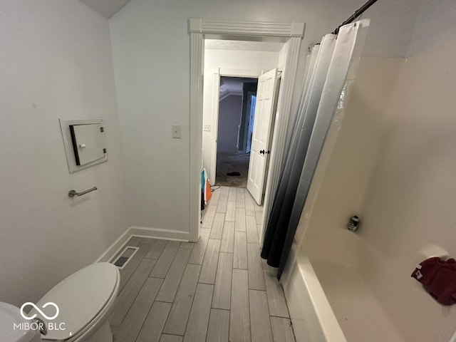 8407 Campbell Ct, Mooresville, IN 46158 - bathroom featuring wood finished floors and shower / bath combo with shower curtain