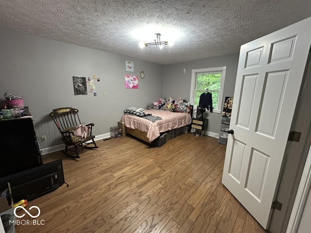 8407 Campbell Ct, Mooresville, IN 46158 - bedroom with wood finished floors and a textured ceiling