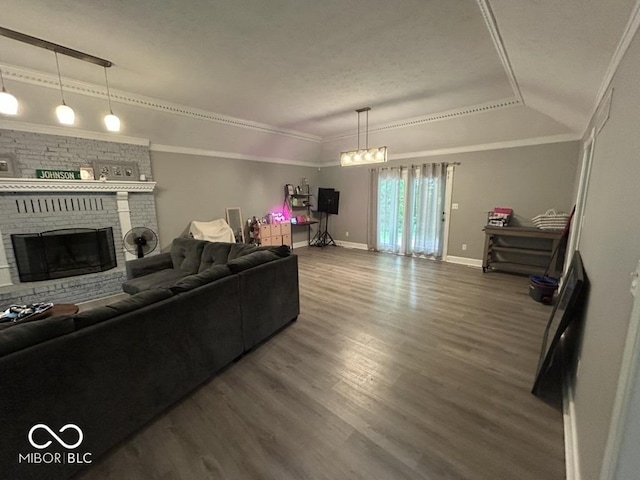 8407 Campbell Ct, Mooresville, IN 46158 - living room featuring wood finished floors, a brick fireplace, ornamental molding, and a raised ceiling