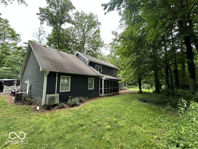 8407 Campbell Ct, Mooresville, IN 46158 - back of property with a sunroom, a yard, and roof with shingles