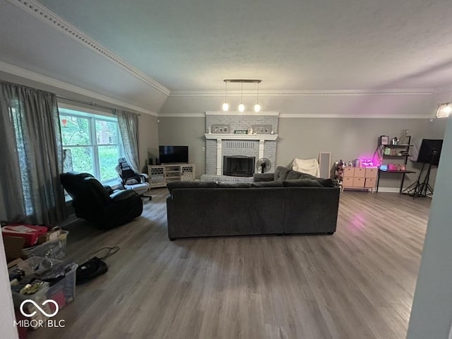 8407 Campbell Ct, Mooresville, IN 46158 - living room featuring crown molding, wood finished floors, and a brick fireplace