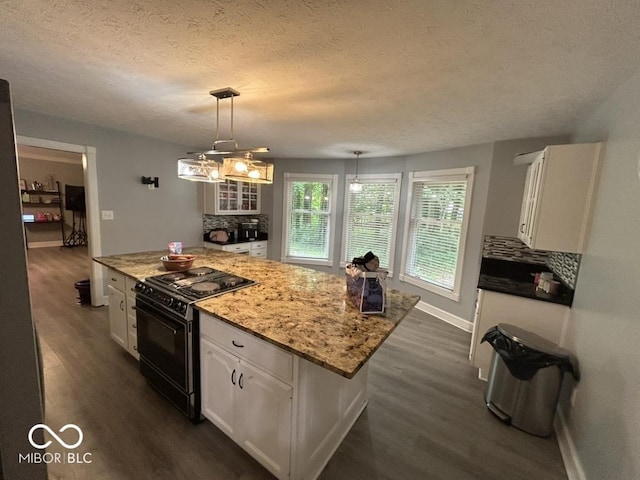 8407 Campbell Ct, Mooresville, IN 46158 - kitchen featuring gas stove, dark wood-type flooring, white cabinetry, a kitchen island, and a textured ceiling
