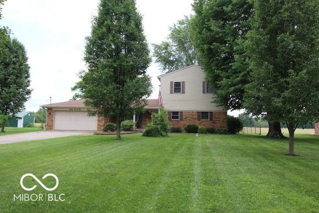 8905 Maze Rd, Indianapolis, IN 46259 - traditional-style house featuring an attached garage, a front lawn, concrete driveway, and brick siding