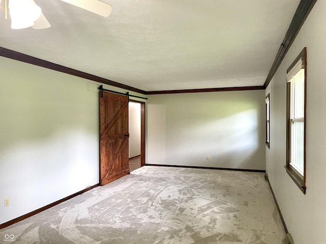540 Lazy Ln, Greenwood, IN 46142 - carpeted spare room with a barn door, ornamental molding, and ceiling fan