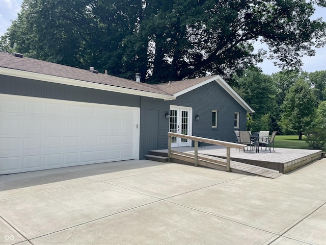 540 Lazy Ln, Greenwood, IN 46142 - view of front of home with french doors, driveway, an attached garage, brick siding, and a shingled roof