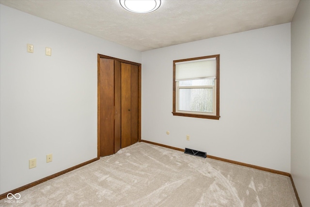 540 Lazy Ln, Greenwood, IN 46142 - unfurnished bedroom with carpet, a closet, and a textured ceiling
