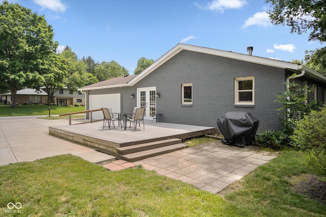 540 Lazy Ln, Greenwood, IN 46142 - back of house featuring french doors, a lawn, a deck, a patio area, and brick siding