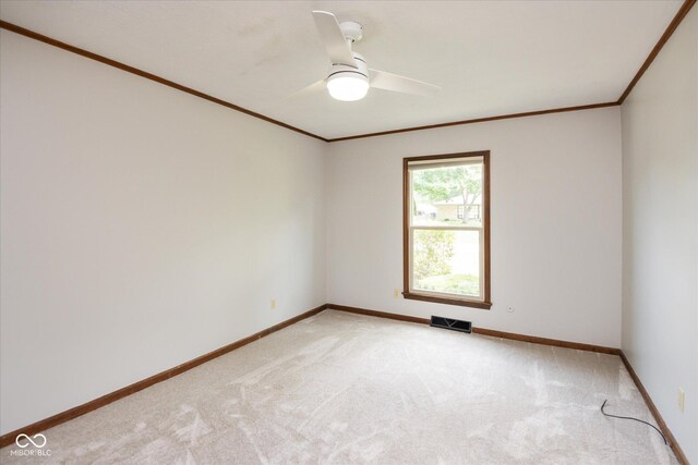 540 Lazy Ln, Greenwood, IN 46142 - spare room featuring crown molding, light carpet, and a ceiling fan