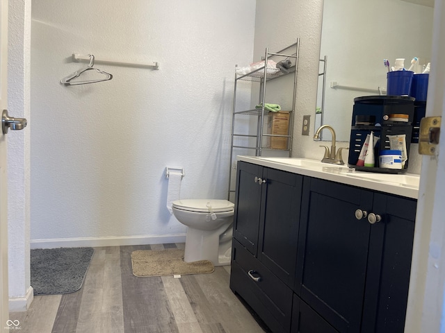 1503 Quinlan Ct, Indianapolis, IN 46217 - bathroom featuring wood finished floors, vanity, and a textured wall