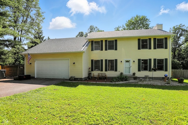 1224 S Hunter Rd, Indianapolis, IN 46239 - colonial house featuring asphalt driveway, a chimney, and an attached garage