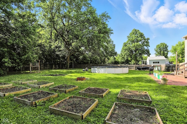1224 S Hunter Rd, Indianapolis, IN 46239 - fenced backyard with a vegetable garden and a patio area