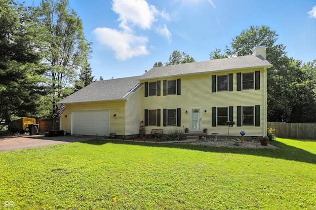 1224 S Hunter Rd, Indianapolis, IN 46239 - colonial home with asphalt driveway, an attached garage, a chimney, and entry steps