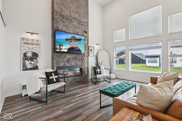 1414 W Springhurst Blvd, Greenfield, IN 46140 - living room featuring wood finished floors, a towering ceiling, and a fireplace
