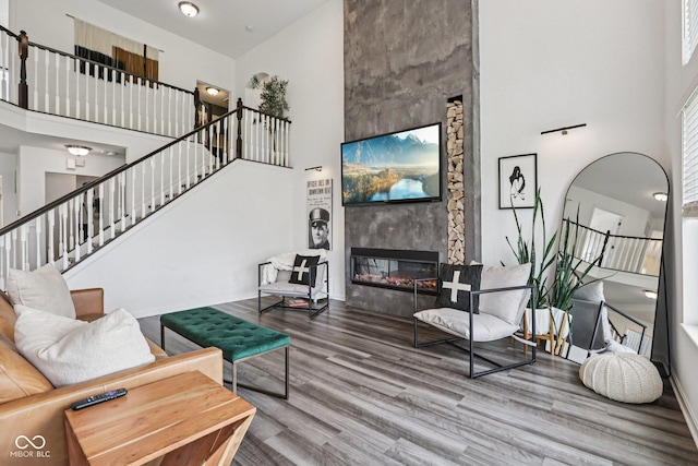 1414 W Springhurst Blvd, Greenfield, IN 46140 - living room featuring a towering ceiling, wood finished floors, stairs, and a fireplace