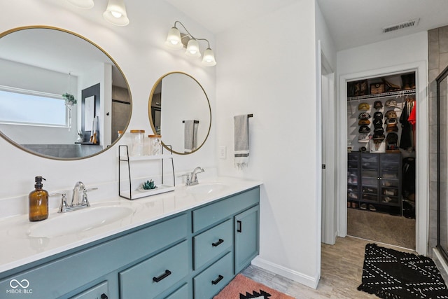 1414 W Springhurst Blvd, Greenfield, IN 46140 - full bath with double vanity, wood finished floors, a walk in closet, and a shower with shower door