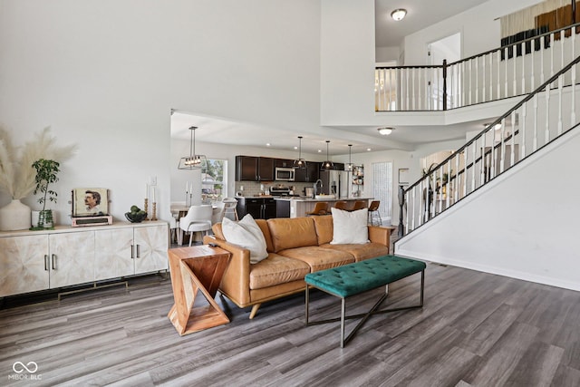 1414 W Springhurst Blvd, Greenfield, IN 46140 - living area with stairs, wood finished floors, a high ceiling, and a chandelier