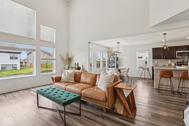 1414 W Springhurst Blvd, Greenfield, IN 46140 - living room featuring dark wood-type flooring, a high ceiling, and a chandelier