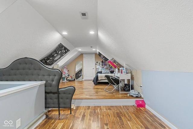 401 N Nicole Ln, Scottsburg, IN 47170 - bedroom with wood-type flooring, vaulted ceiling, a textured ceiling, and recessed lighting