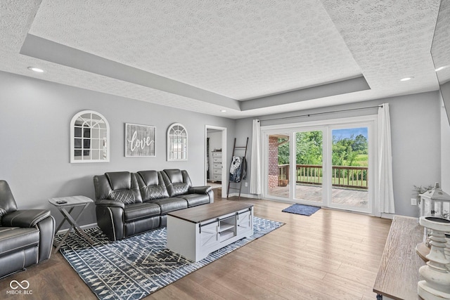 401 N Nicole Ln, Scottsburg, IN 47170 - living room with a textured ceiling, a tray ceiling, wood finished floors, and recessed lighting
