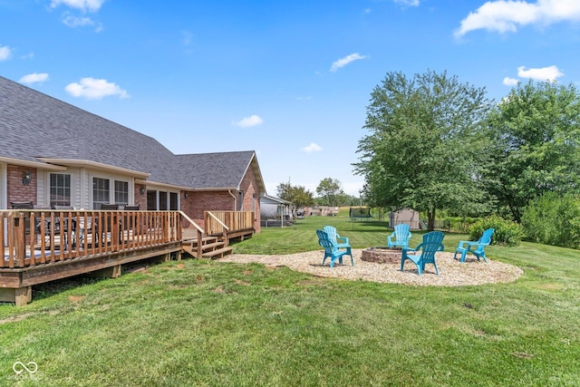 401 N Nicole Ln, Scottsburg, IN 47170 - view of grassy yard featuring an outdoor fire pit and a deck