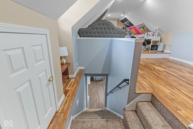 401 N Nicole Ln, Scottsburg, IN 47170 - stairway with lofted ceiling, a textured ceiling, and wood finished floors