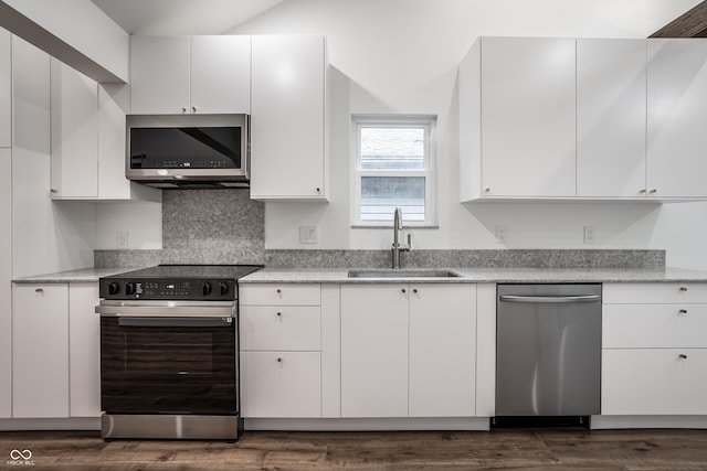 4245 Norwaldo Ave, Indianapolis, IN 46205 - kitchen featuring appliances with stainless steel finishes, white cabinetry, backsplash, and dark wood-style floors