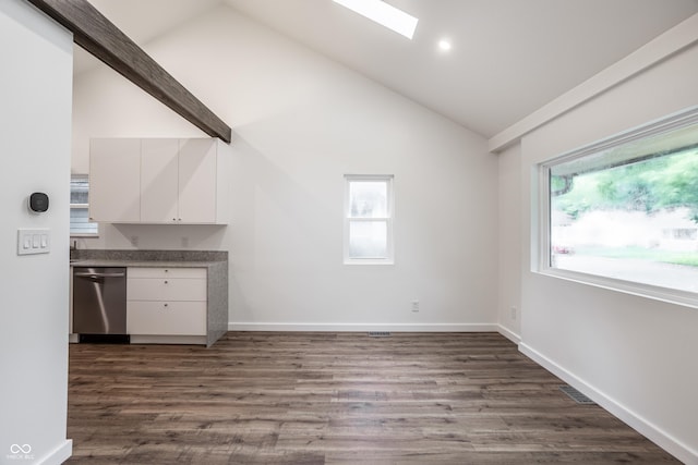 4245 Norwaldo Ave, Indianapolis, IN 46205 - unfurnished living room with bar area, dark wood-style floors, high vaulted ceiling, a skylight, and recessed lighting