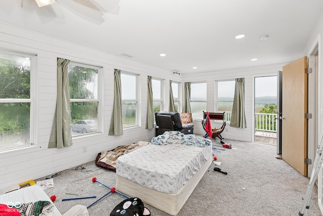 8783 State Road 56, Aurora, IN 47001 - carpeted bedroom featuring access to exterior, recessed lighting, and wooden walls