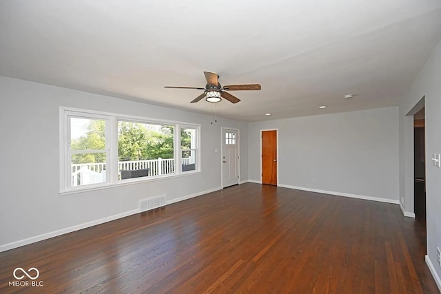 8783 State Road 56, Aurora, IN 47001 - unfurnished living room featuring ceiling fan and dark wood-style flooring