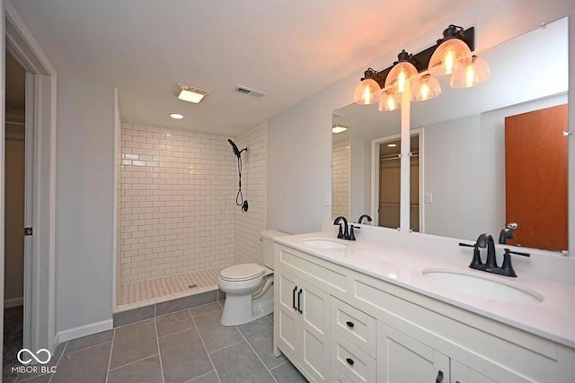 8783 State Road 56, Aurora, IN 47001 - bathroom with a tile shower, double vanity, and tile patterned flooring