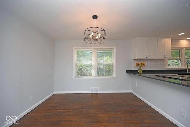 8783 State Road 56, Aurora, IN 47001 - unfurnished dining area featuring a chandelier, dark wood-style flooring, and recessed lighting