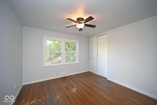 8783 State Road 56, Aurora, IN 47001 - unfurnished bedroom with wood finished floors, a closet, and ceiling fan