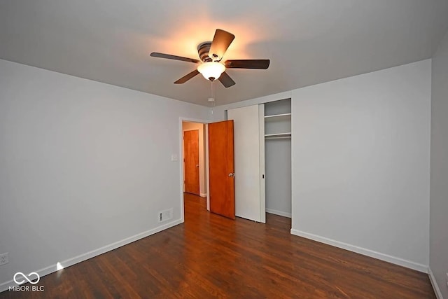 8783 State Road 56, Aurora, IN 47001 - unfurnished bedroom featuring dark wood-style flooring, a closet, and a ceiling fan