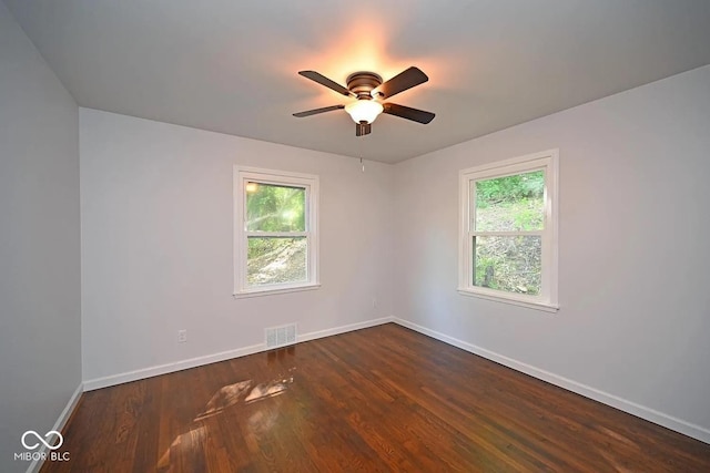 8783 State Road 56, Aurora, IN 47001 - spare room with plenty of natural light, a ceiling fan, and dark wood-type flooring