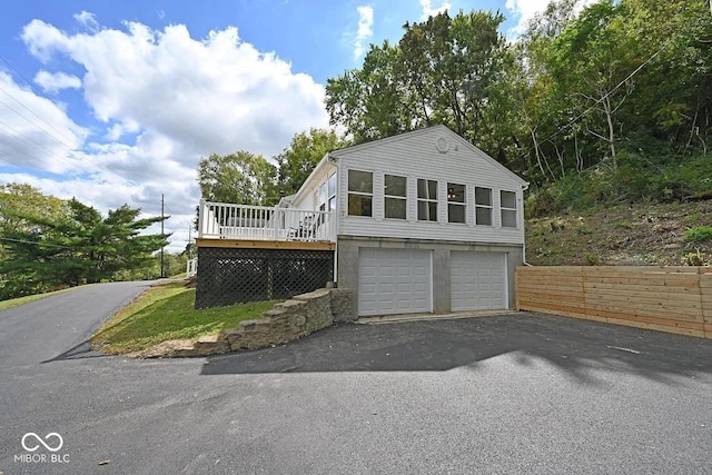 8783 State Road 56, Aurora, IN 47001 - view of home's exterior featuring driveway, a wooden deck, and a garage