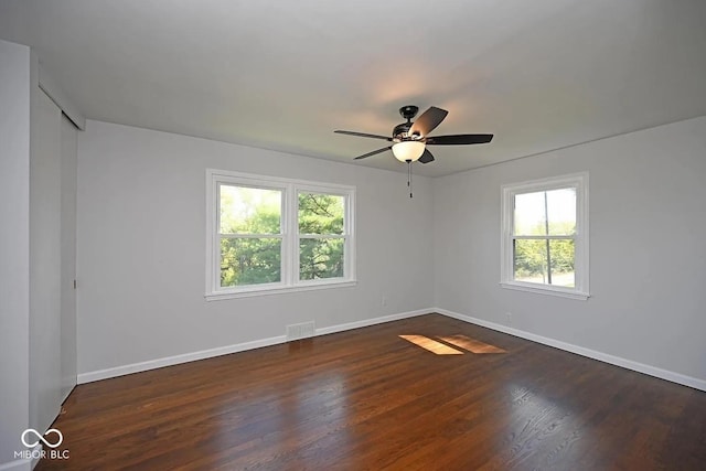 8783 State Road 56, Aurora, IN 47001 - spare room featuring healthy amount of natural light, dark wood-type flooring, and ceiling fan