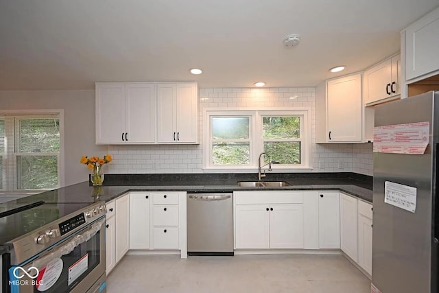 8783 State Road 56, Aurora, IN 47001 - kitchen featuring stainless steel appliances, healthy amount of natural light, white cabinetry, decorative backsplash, and recessed lighting