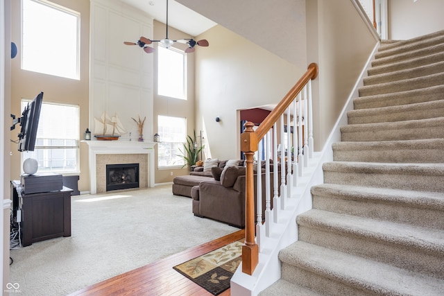 1521 Midnight Pass, Brownsburg, IN 46112 - living room with a towering ceiling, stairs, wood finished floors, a tiled fireplace, and ceiling fan