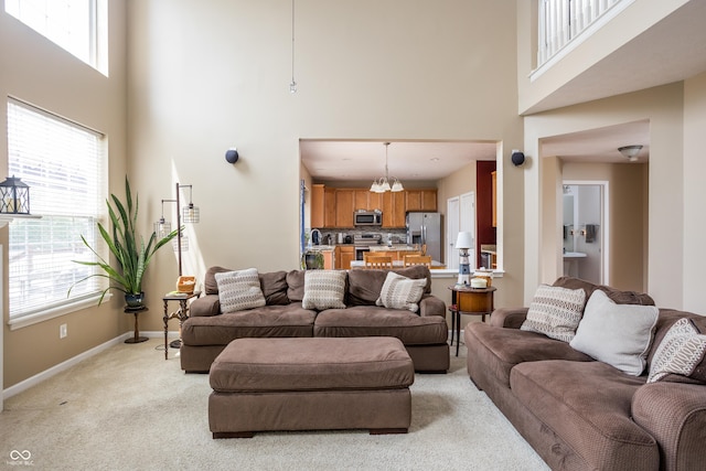 1521 Midnight Pass, Brownsburg, IN 46112 - living area with a high ceiling, light colored carpet, and a chandelier