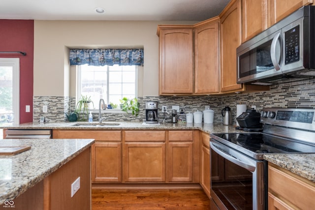 1521 Midnight Pass, Brownsburg, IN 46112 - kitchen featuring appliances with stainless steel finishes, wood finished floors, plenty of natural light, light stone counters, and recessed lighting