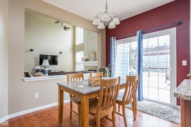 1521 Midnight Pass, Brownsburg, IN 46112 - dining space with a chandelier, wood finished floors, and a fireplace