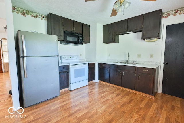 923 Bogalusa Ct, Indianapolis, IN 46217 - kitchen with freestanding refrigerator, black microwave, white range with electric cooktop, and light wood-style flooring