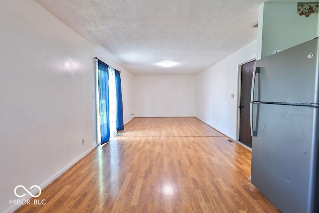 923 Bogalusa Ct, Indianapolis, IN 46217 - unfurnished room featuring light wood-type flooring and a textured ceiling
