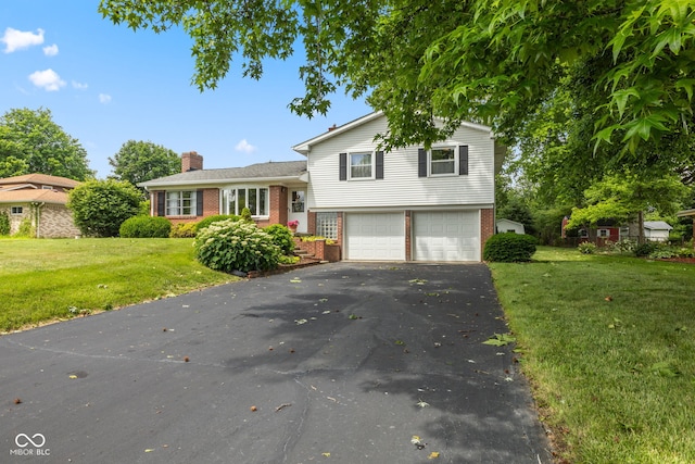 3388 S Leonard Rd, New Palestine, IN 46163 - view of front of home with brick siding, an attached garage, driveway, and a chimney